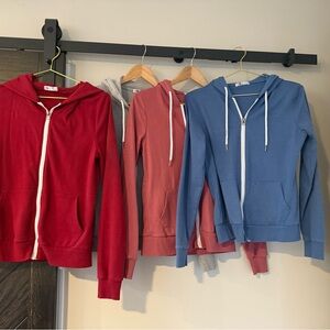 Red, Pink, and Blue Zip-Up Hoodies